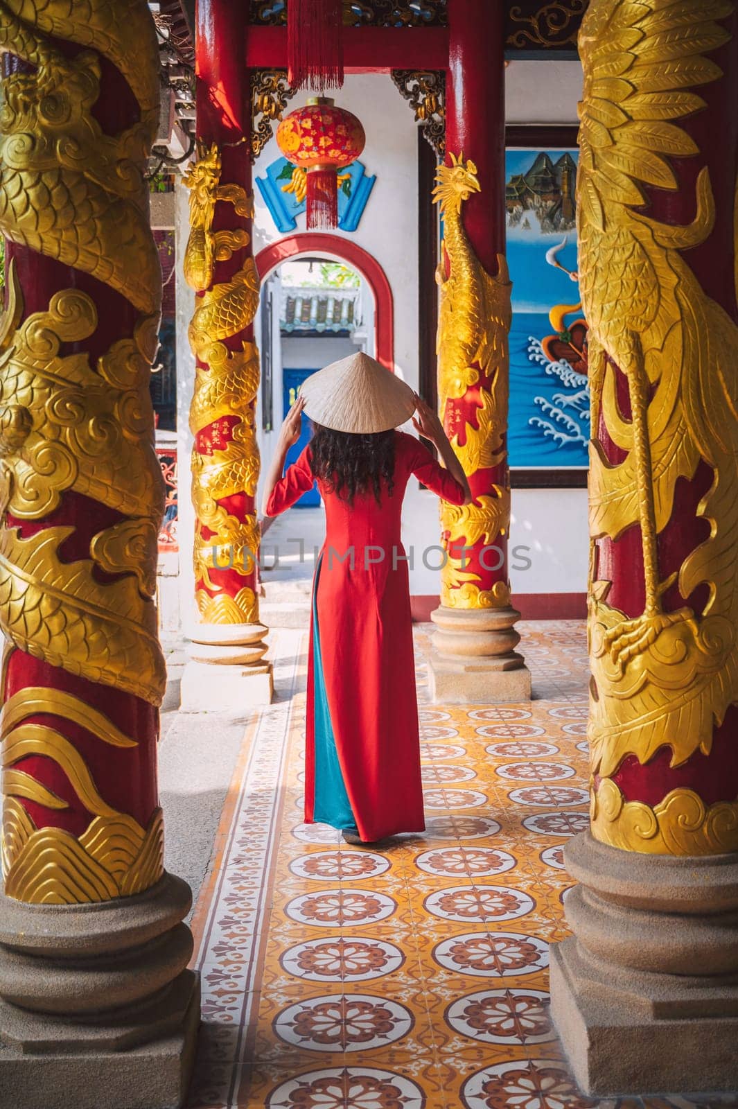 back of an Asian female tourist traveling in a temple on pagoda in Vietnam in Asia