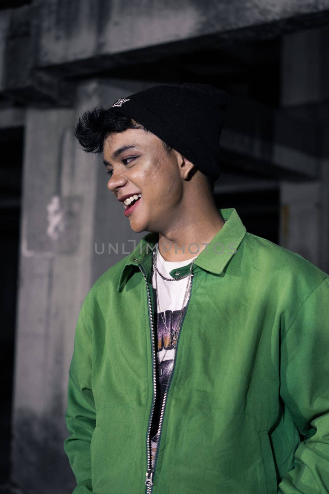 an Asian man is standing in an abandoned building in an eccentric outfit at night