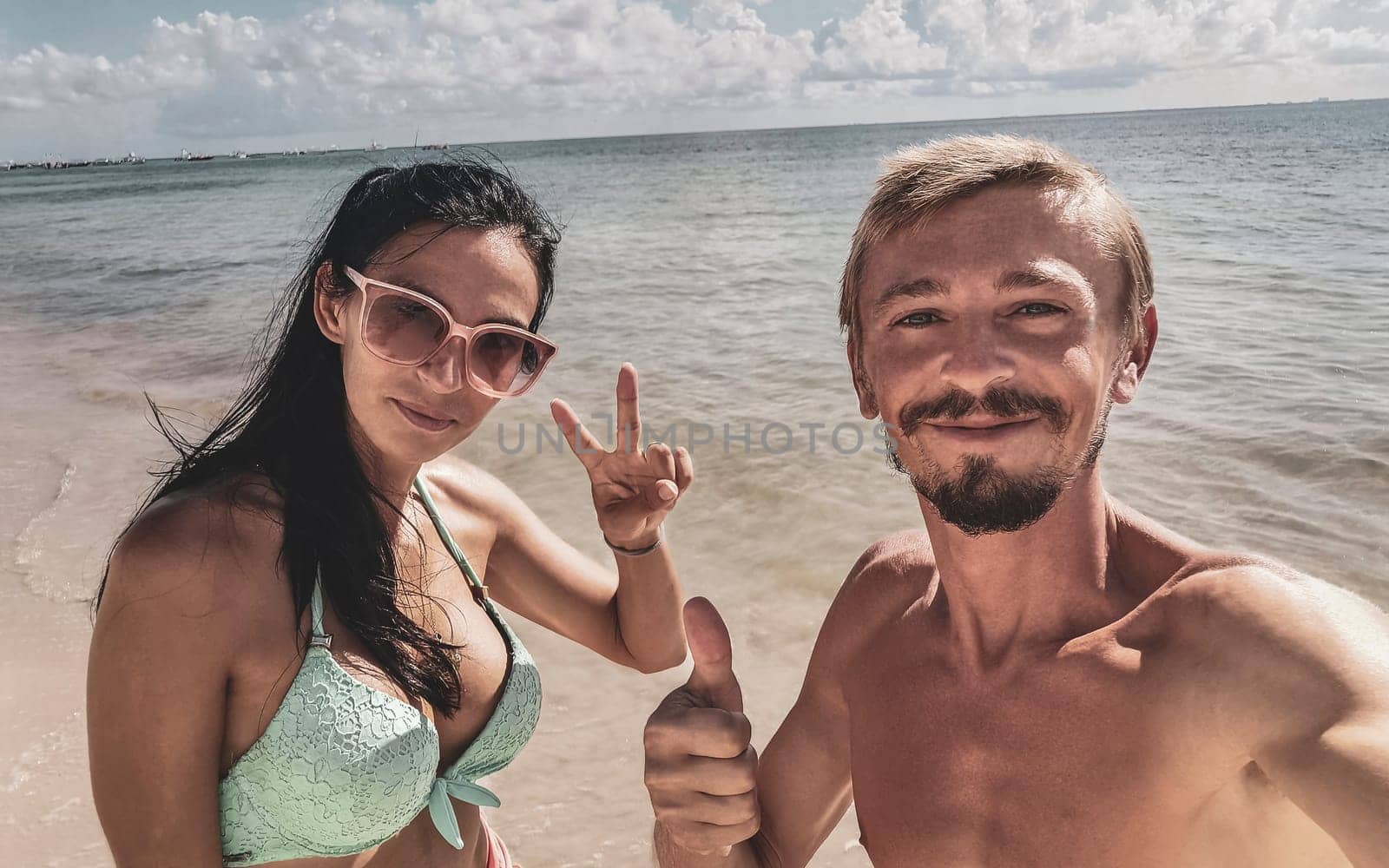 Couple man and woman together at the Caribbean beach and sea in Playa del Carmen Quintana Roo Mexico.