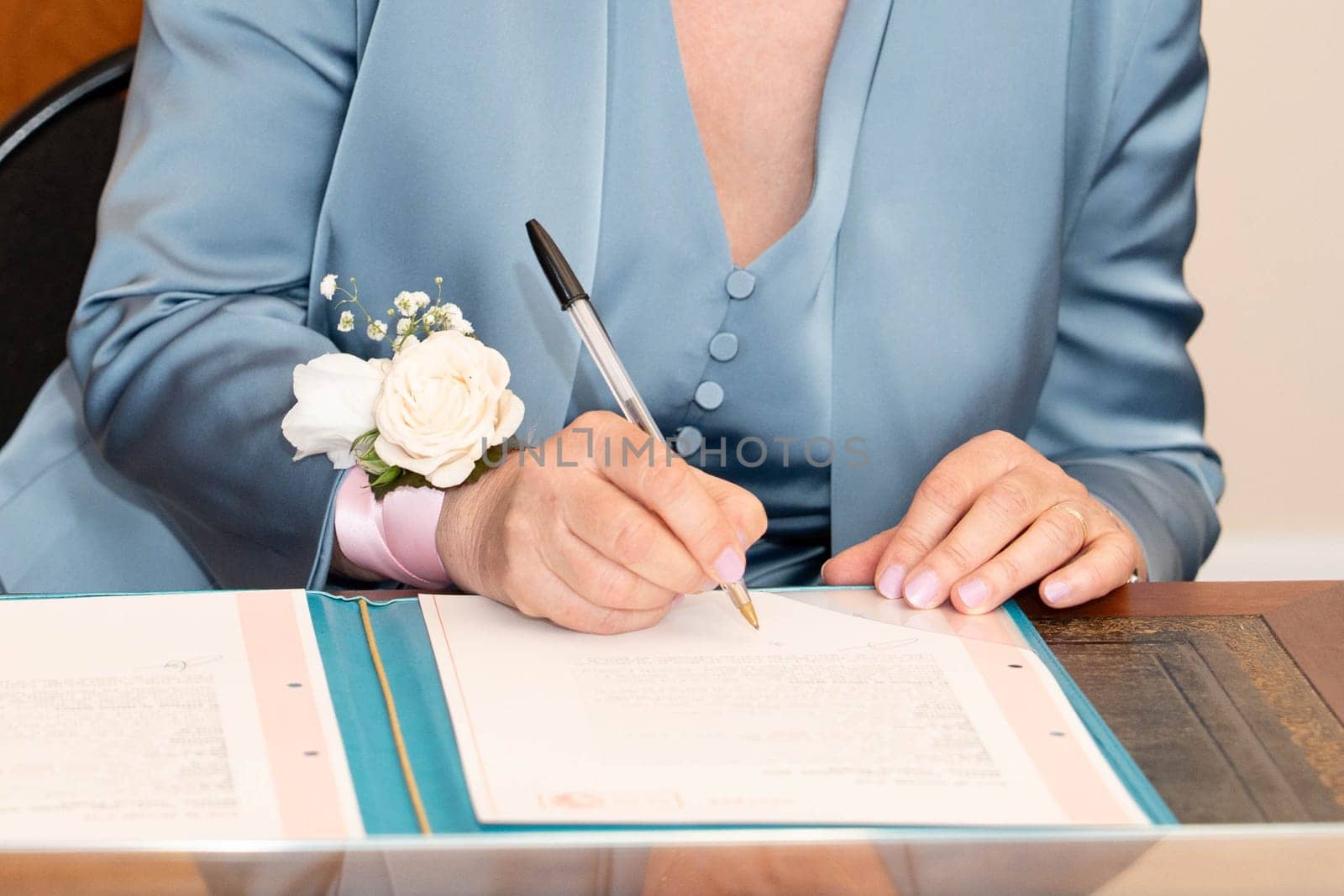 A bride signs the marriage registration documents