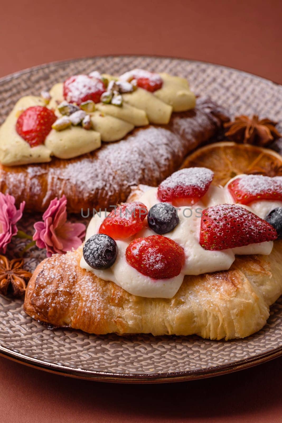 Food for breakfast sweet strawberry croissants with chocolate filling. French dessert, croissants with fruit and berries