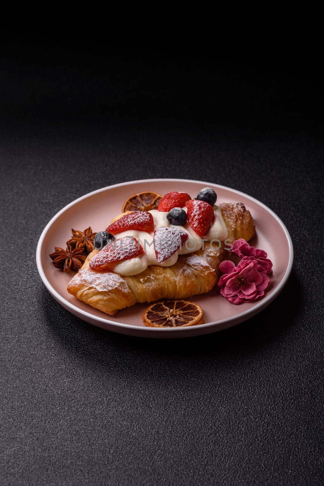 Food for breakfast sweet strawberry croissants with chocolate filling. French dessert, croissants with fruit and berries
