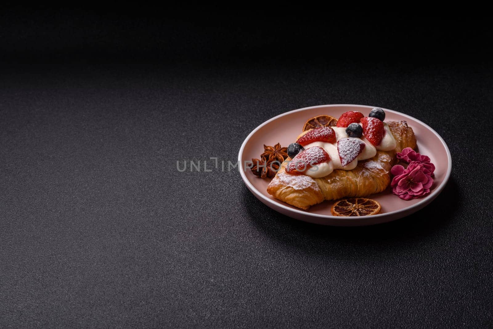 Food for breakfast sweet strawberry croissants with chocolate filling. French dessert, croissants with fruit and berries