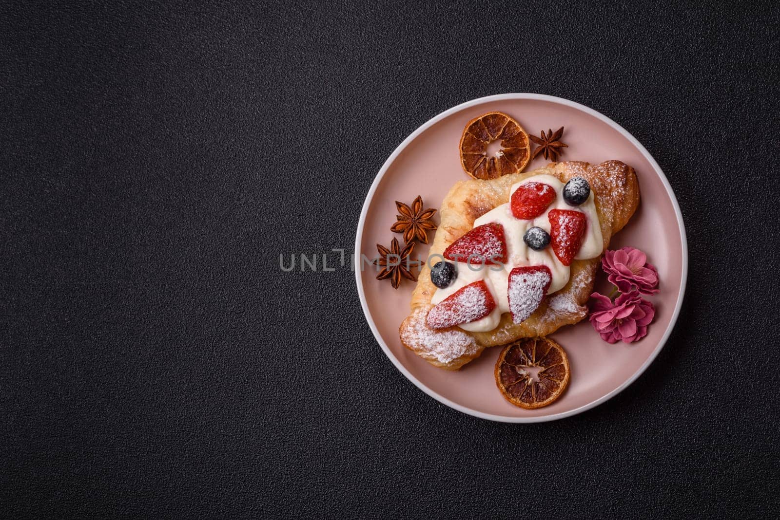 Food for breakfast sweet strawberry croissants with chocolate filling. French dessert, croissants with fruit and berries