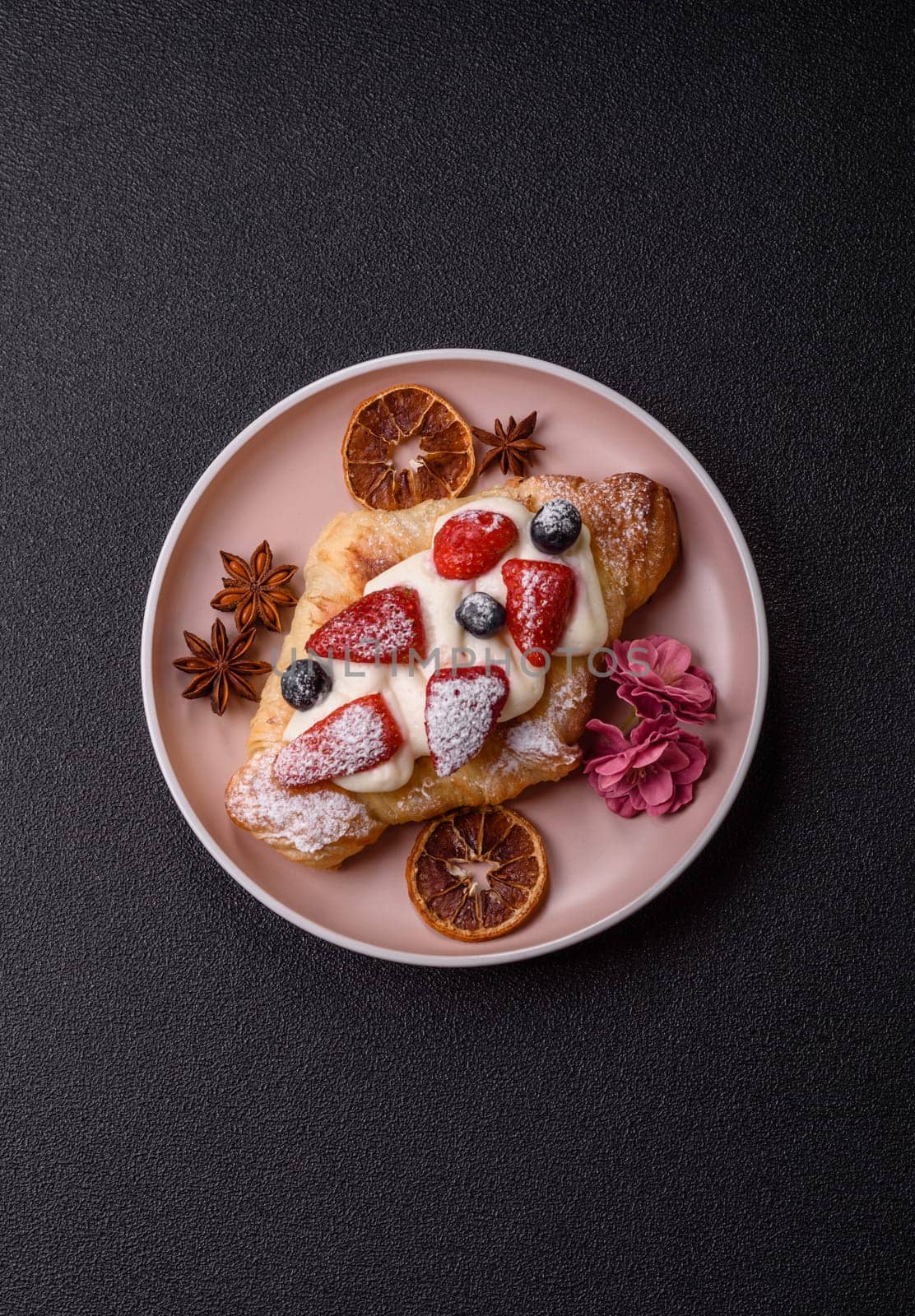 Food for breakfast sweet strawberry croissants with chocolate filling. French dessert, croissants with fruit and berries
