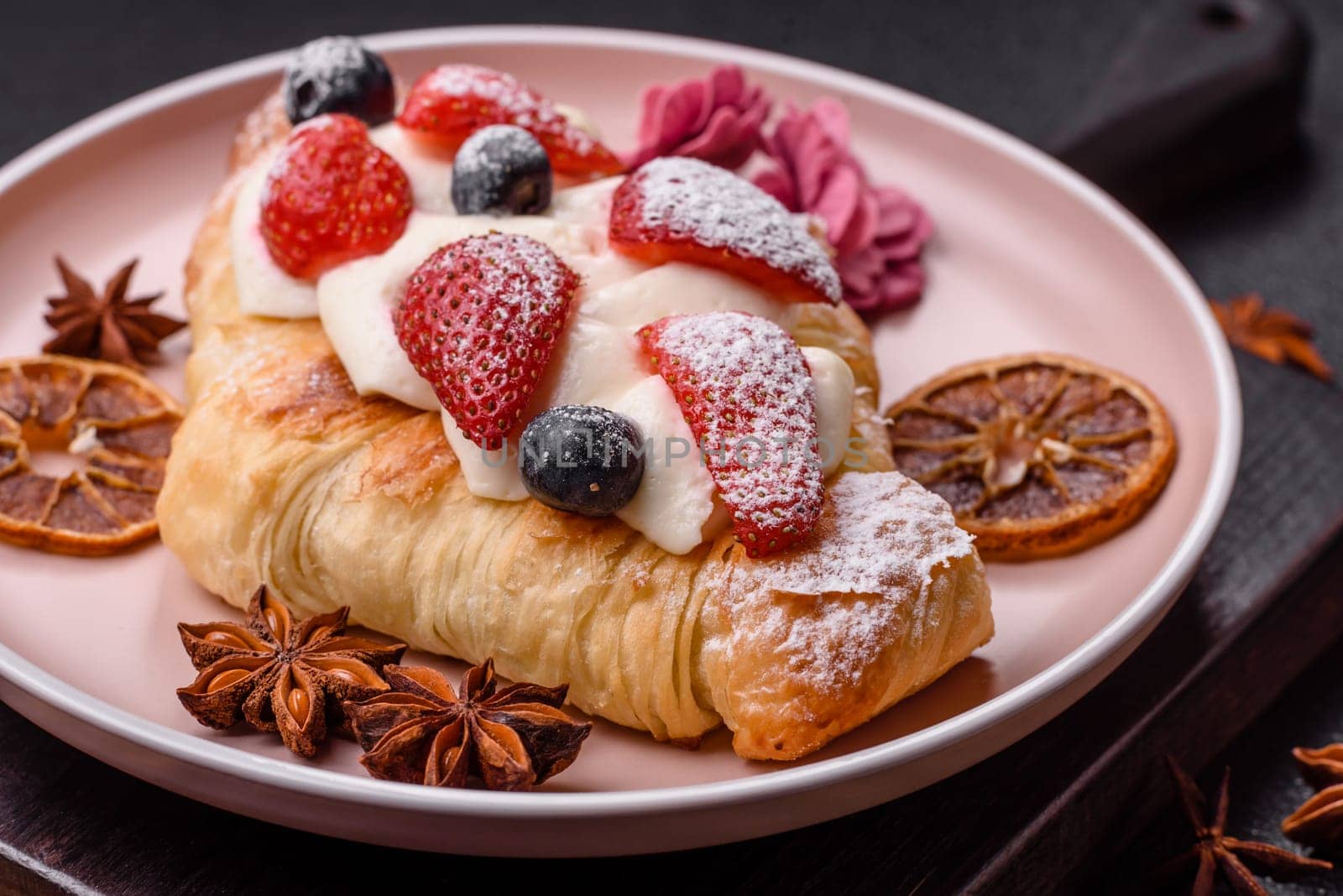 Food for breakfast sweet strawberry croissants with chocolate filling. French dessert, croissants with fruit and berries