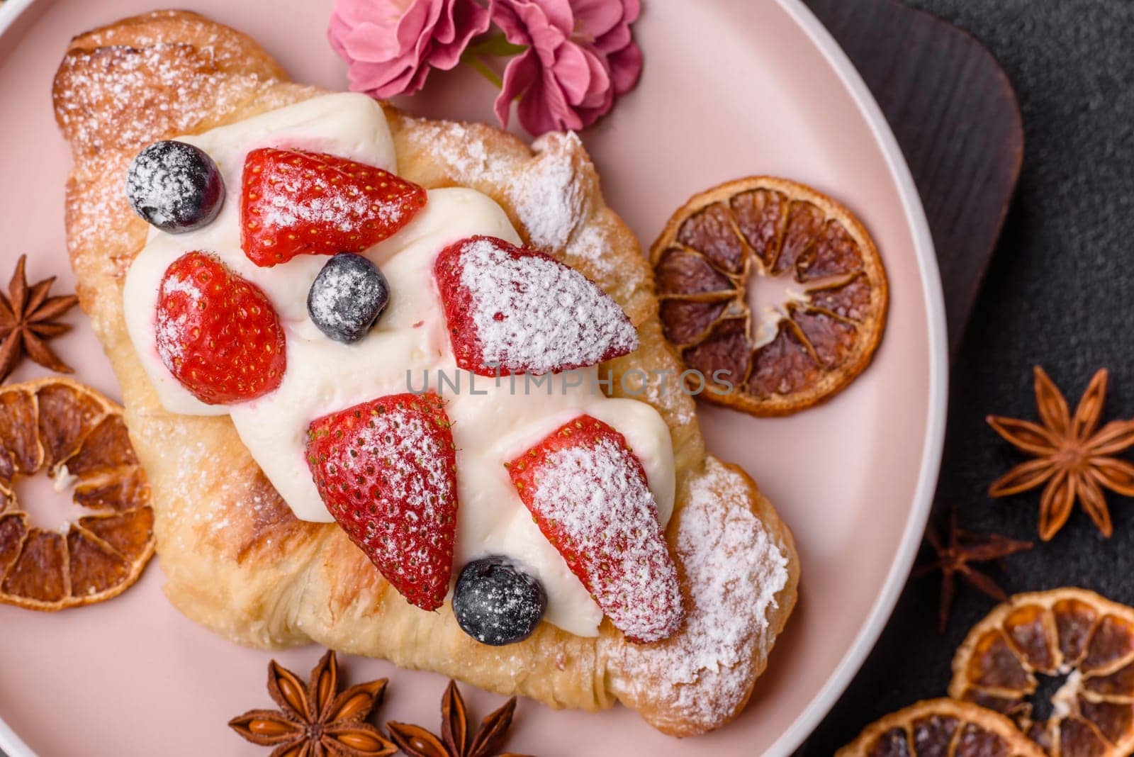 Food for breakfast sweet strawberry croissants with chocolate filling. French dessert, croissants with fruit and berries
