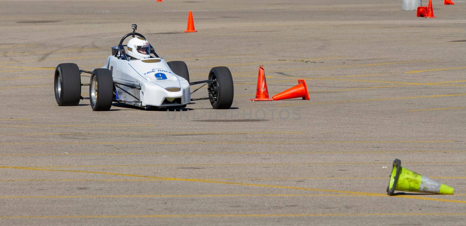 September 11, 2016 - Boise, Idaho:A race car is driving on a track with orange cones. The car is white and black and is in the middle of the track