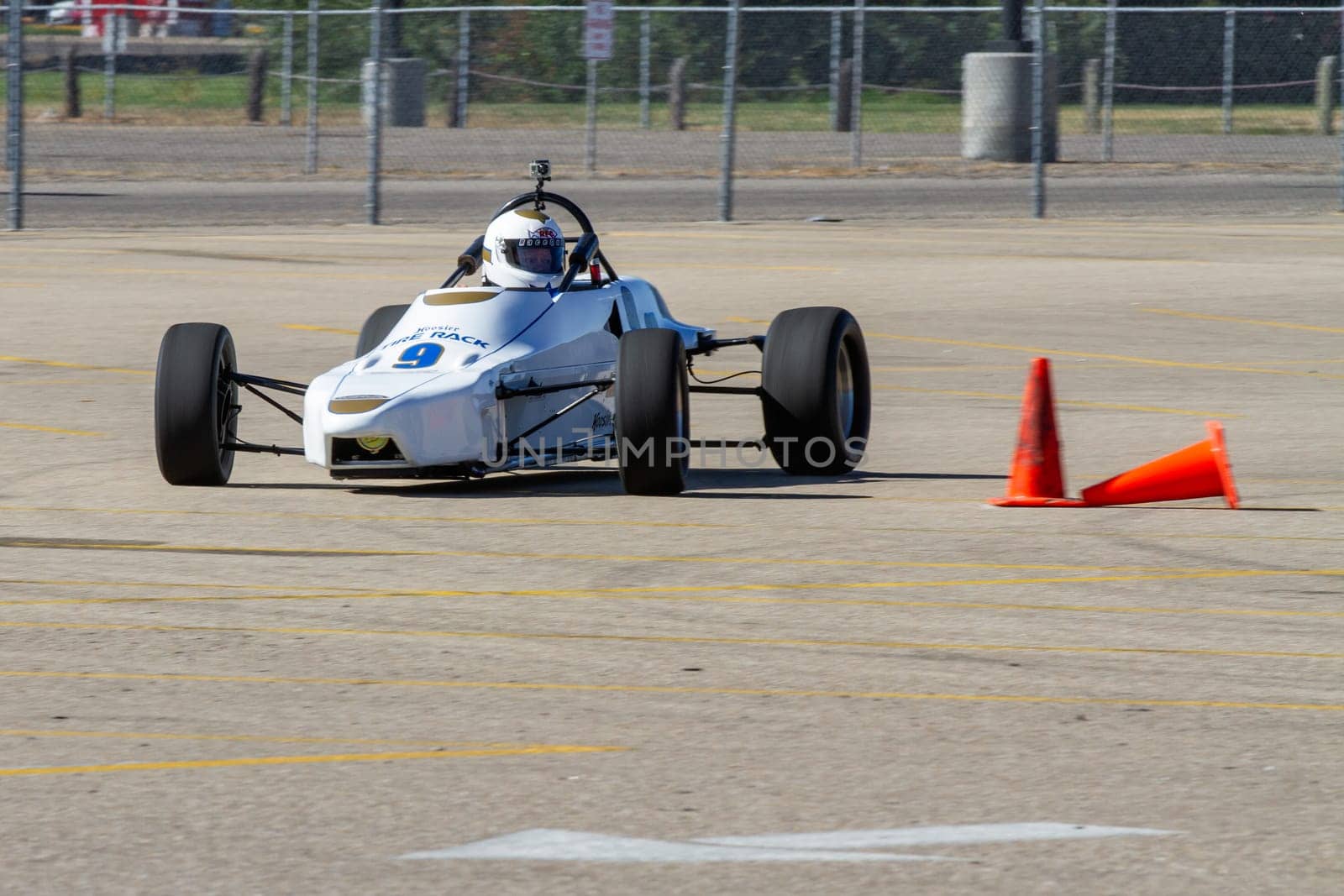 September 11, 2016 - Boise, Idaho: A white race car is driving on a track with a cone in the way. The driver is focused on the track ahead