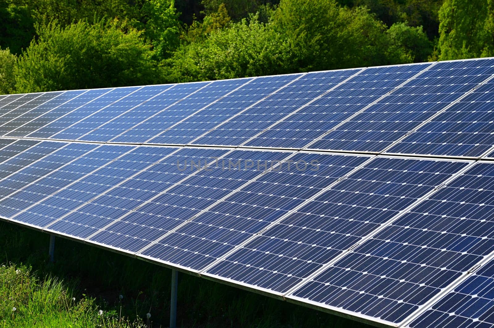 Solar power plant - concept for electricity and ecological industry. High energy prices. Beautiful landscape and sunny day with blue sky. Photovoltaic power plant.