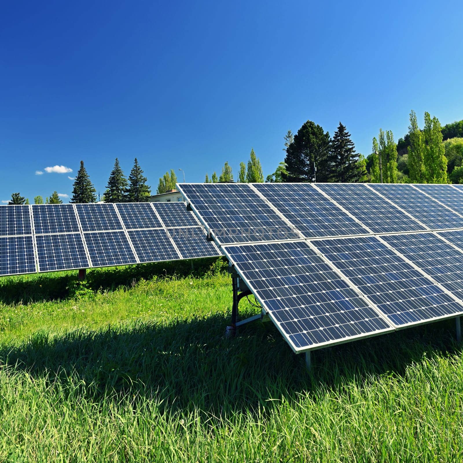 Solar power plant - concept for electricity and ecological industry. High energy prices. Beautiful landscape and sunny day with blue sky. Photovoltaic power plant.