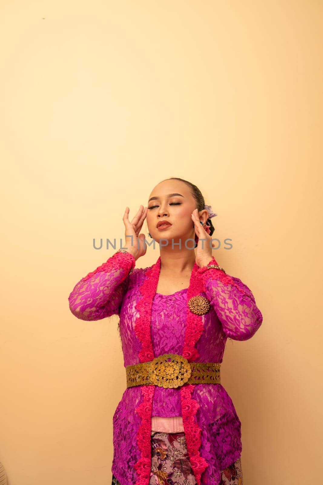 Beautiful bride from Balinese woman with pink dresses and make up on her face before the ceremony began