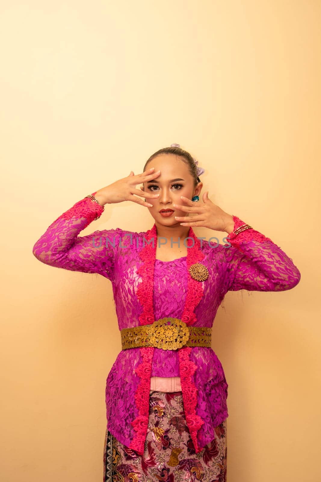Beautiful bride from Balinese woman with pink dresses and make up on her face before the ceremony began