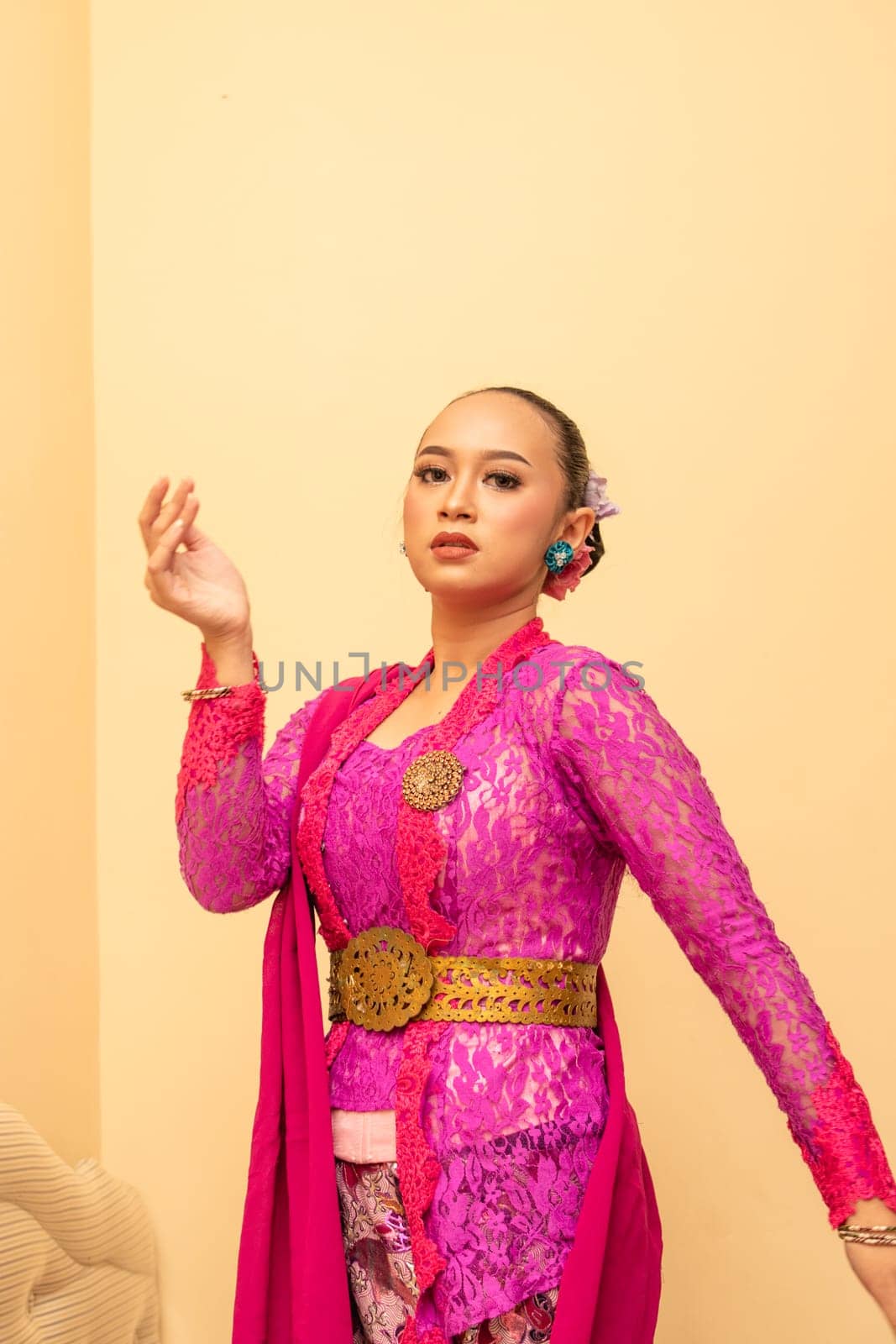 Javanese woman wearing traditional pink dress called kebaya on the Indonesian independence day