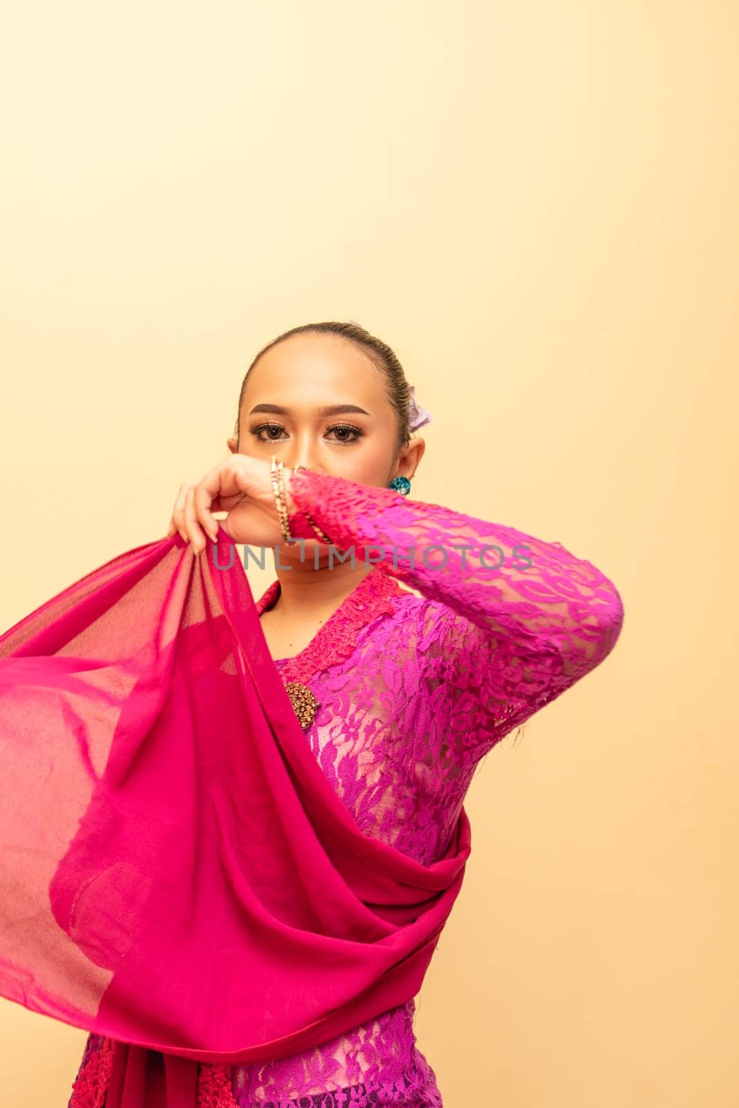 Javanese woman wearing traditional pink dress called kebaya on the Indonesian independence day