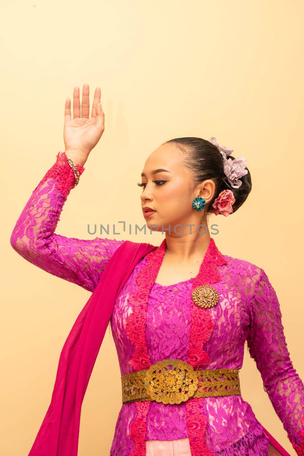 Javanese woman wearing traditional pink dress called kebaya on the Indonesian independence day