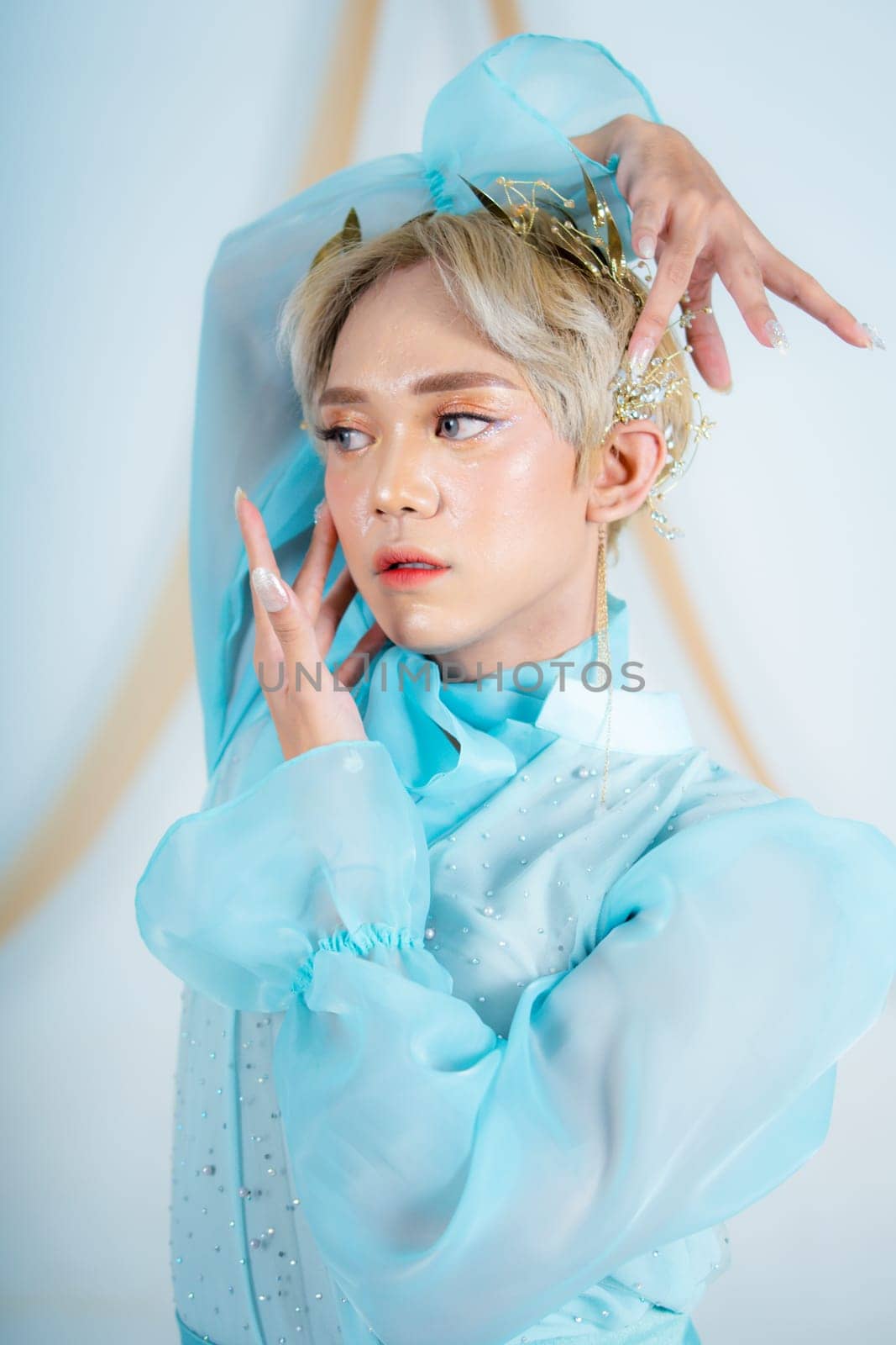 beautiful face of an asian woman with red lipstick and blue eyes in a white studio
