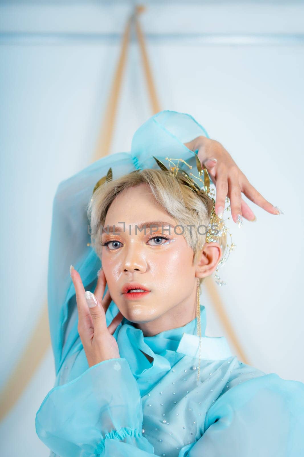 beautiful face of an asian woman with red lipstick and blue eyes in a white studio