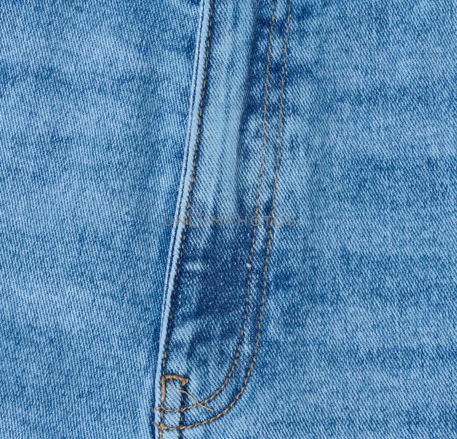 Close up of blue denim jeans showing the fly and zipper seam