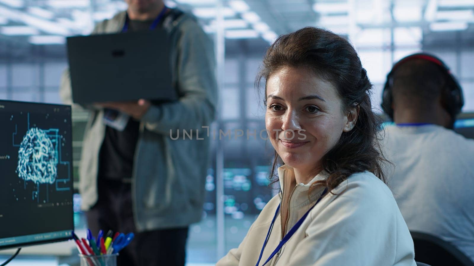 Portrait of upbeat woman working in high tech AI facility providing computing resources for different workloads. Joyous admin checking on artificial intelligence data center supercomputers, camera A