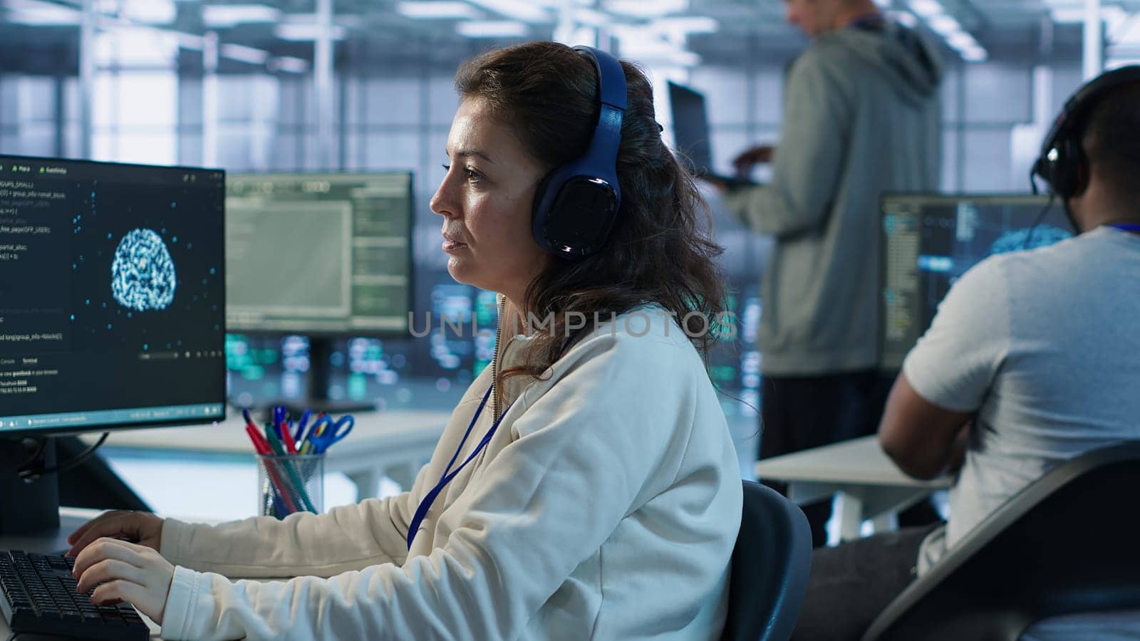 Developer listening music while programming in AI data center used for machine learning training. IT specialist wearing headphones running code to upgrade artificial intelligence tech, camera A