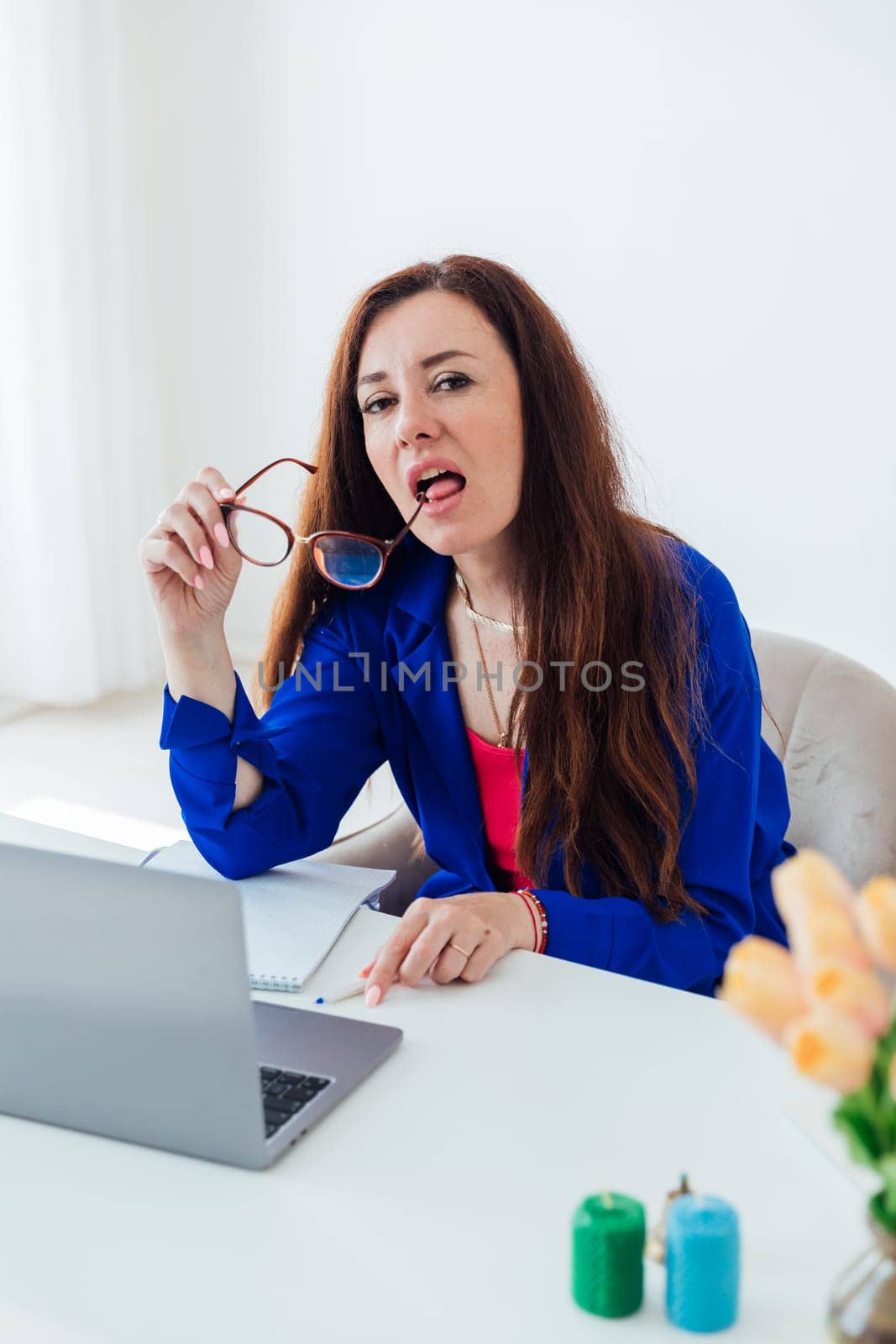 Women brunette woman in business suit with glasses at desk with laptop online