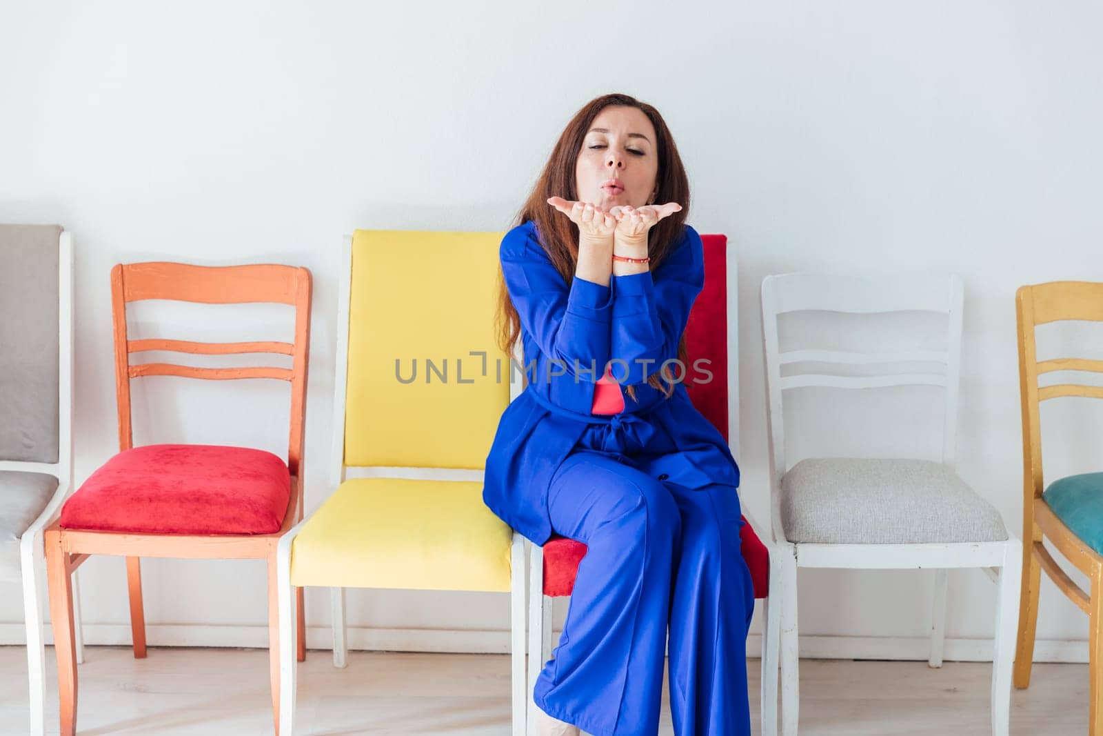 Brunette woman in blue business suit showing kiss
