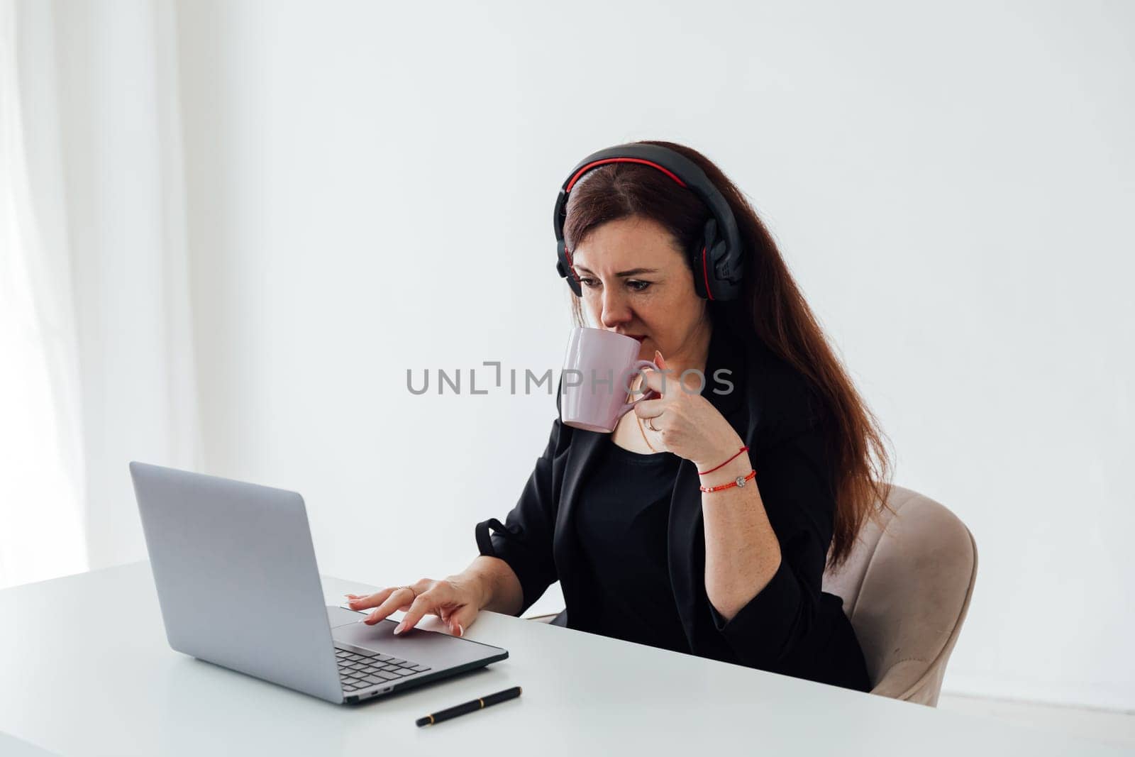 brunette woman working at desk operator remotely online