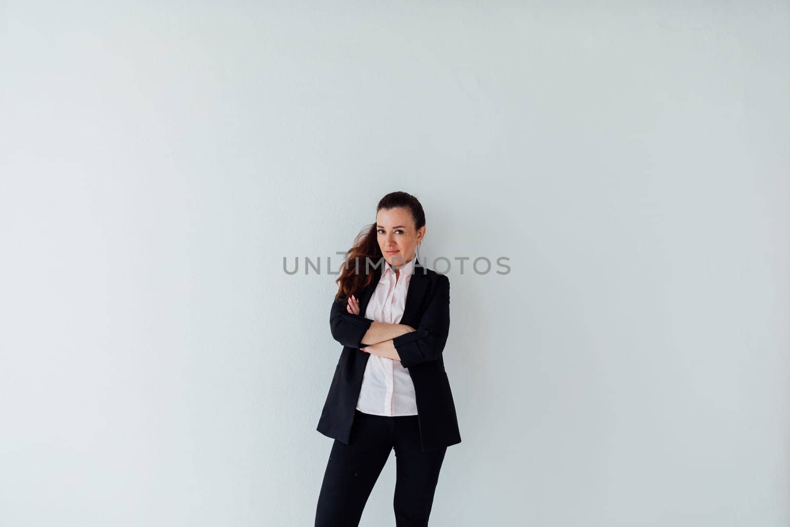 Brunette woman in business suit posing on white background