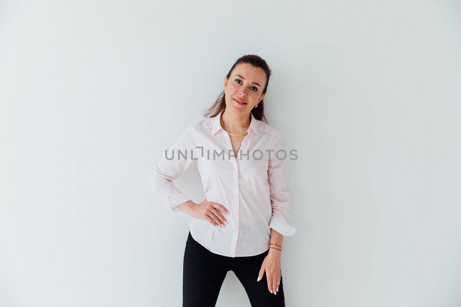 Brunette woman in business suit posing on white background