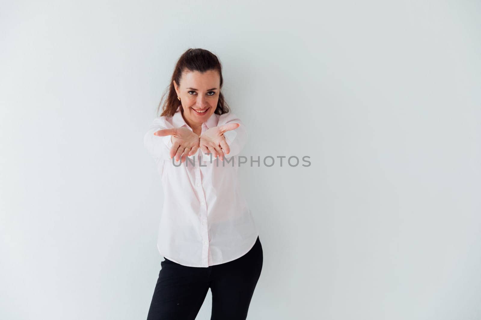 brunette woman stretching her hands forward and smiling