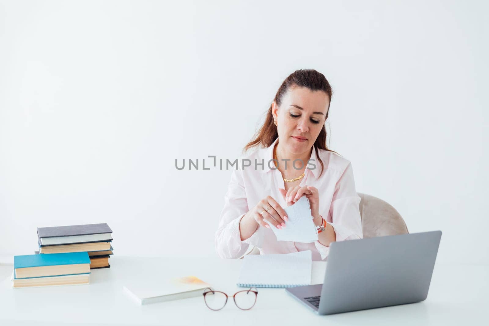 Brunette woman working at office desk with laptop online