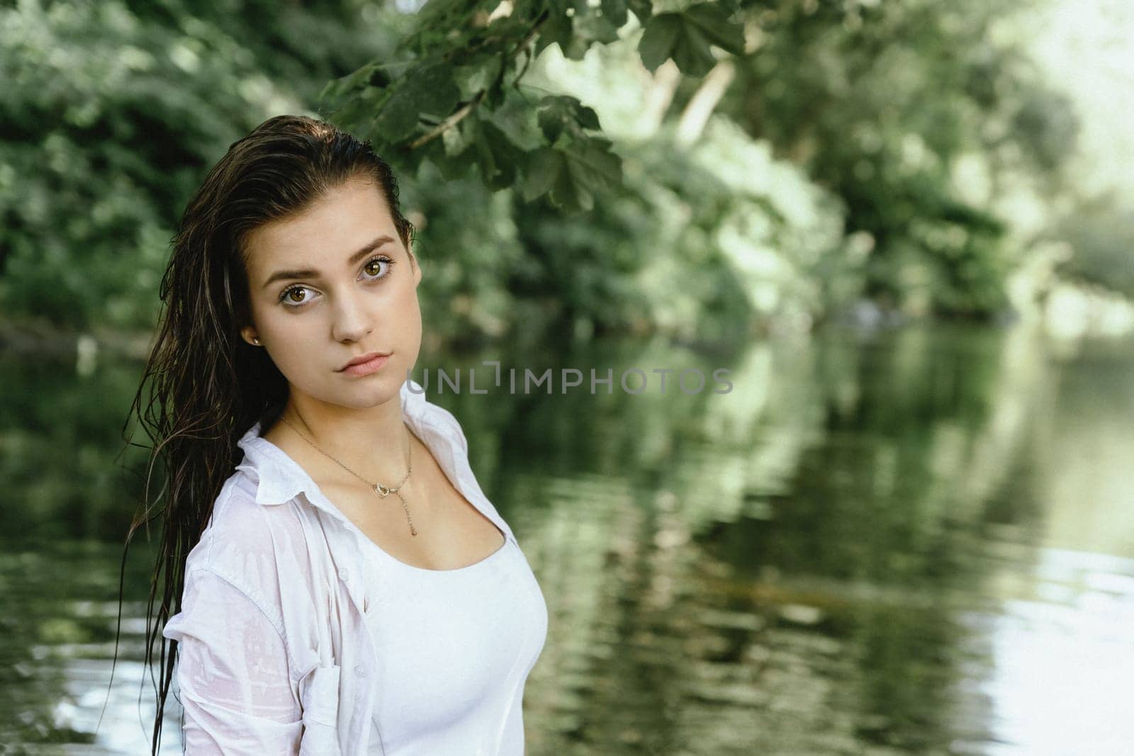 Cool brunette long wet hair girl is posing on camera outdoors. Edited as a old  photo.. Horizontally. 
