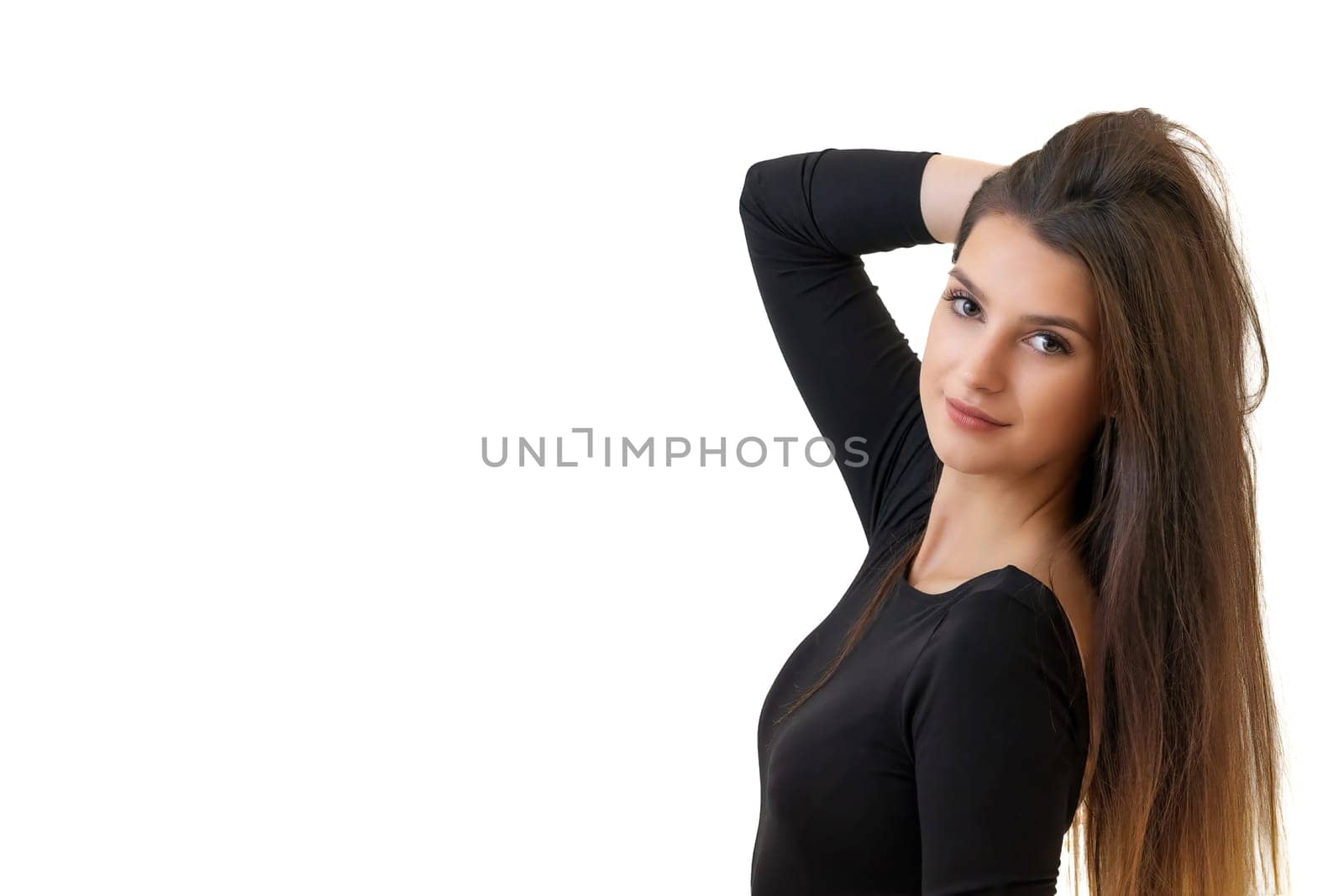 Studio waist up portrait of a beautiful young brunette long haired woman. Isolated on white background. Horizontally. 