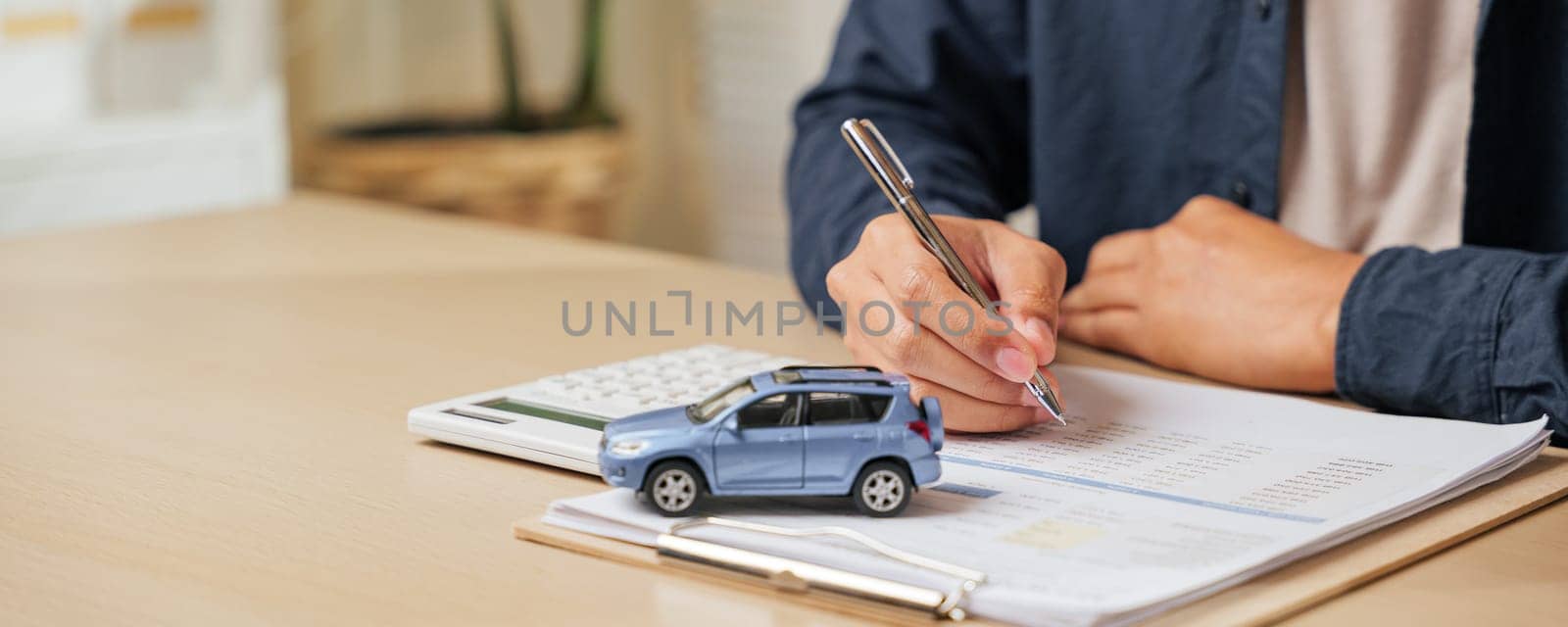 Signing a car lease paper or agreement, ensuring finance, loan, or rent terms. Perfect for vehicle purchases or dealership transactions in auto sales and insurance contracts.