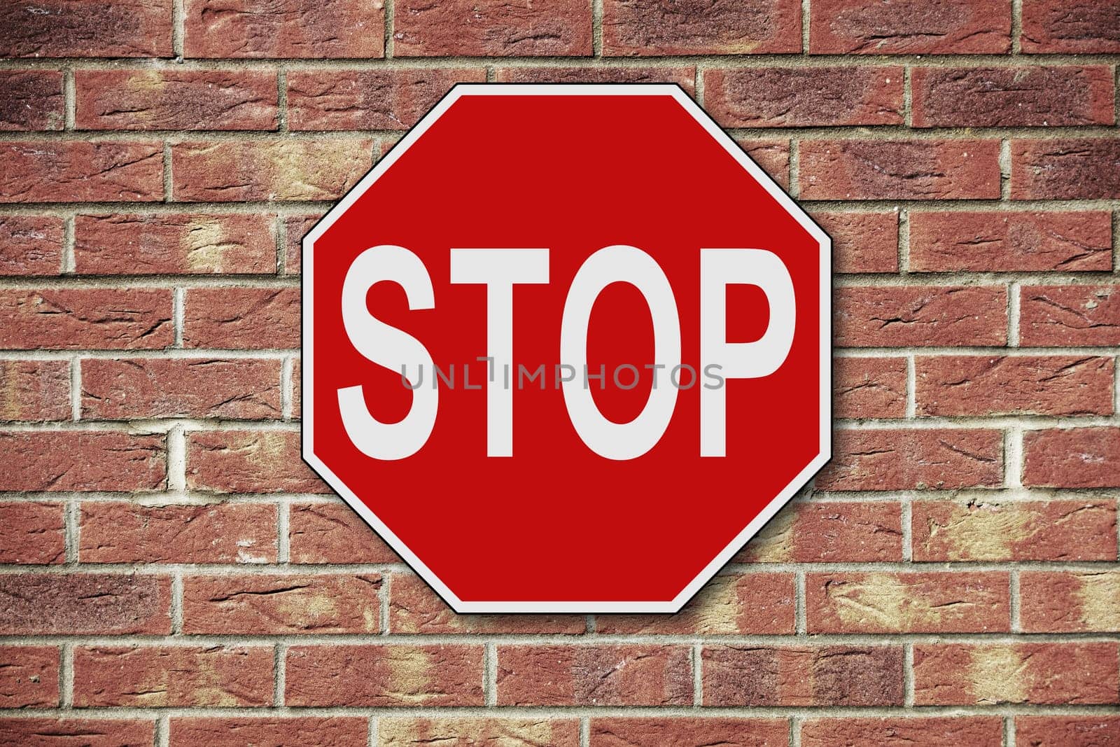 Stop sign on a brick wall background