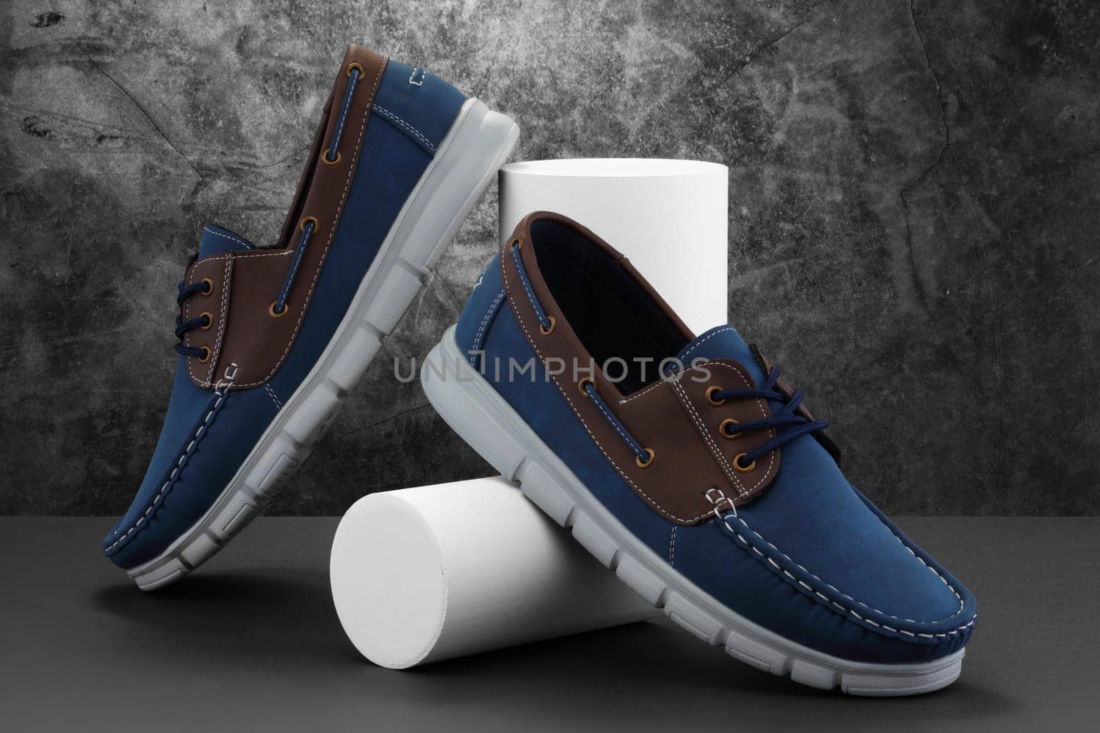 Blue men's shoes on a split marble background