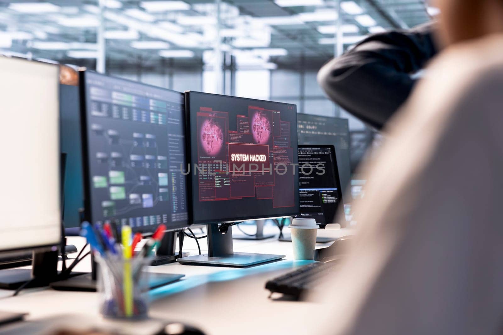 Server hub colleagues cooperating to protect hardware from hacker attack stealing info. Group of data center programmers trying to erase virus after seeing security breach alert on monitor