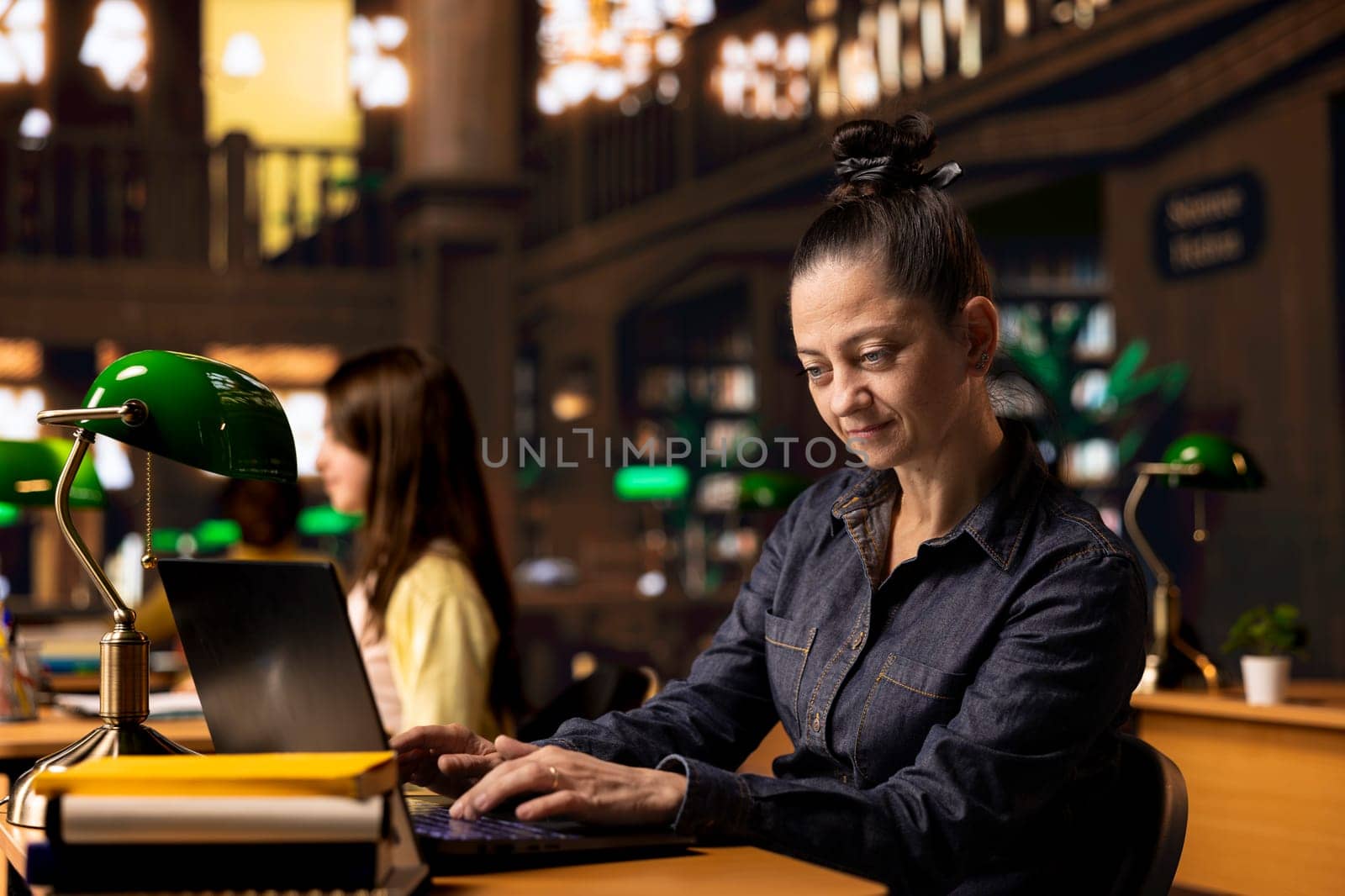 Educator preparing documents and learning materials for her teaching session in an academic environment. Intelligent tutor providing academic resources for pupils at the study area.