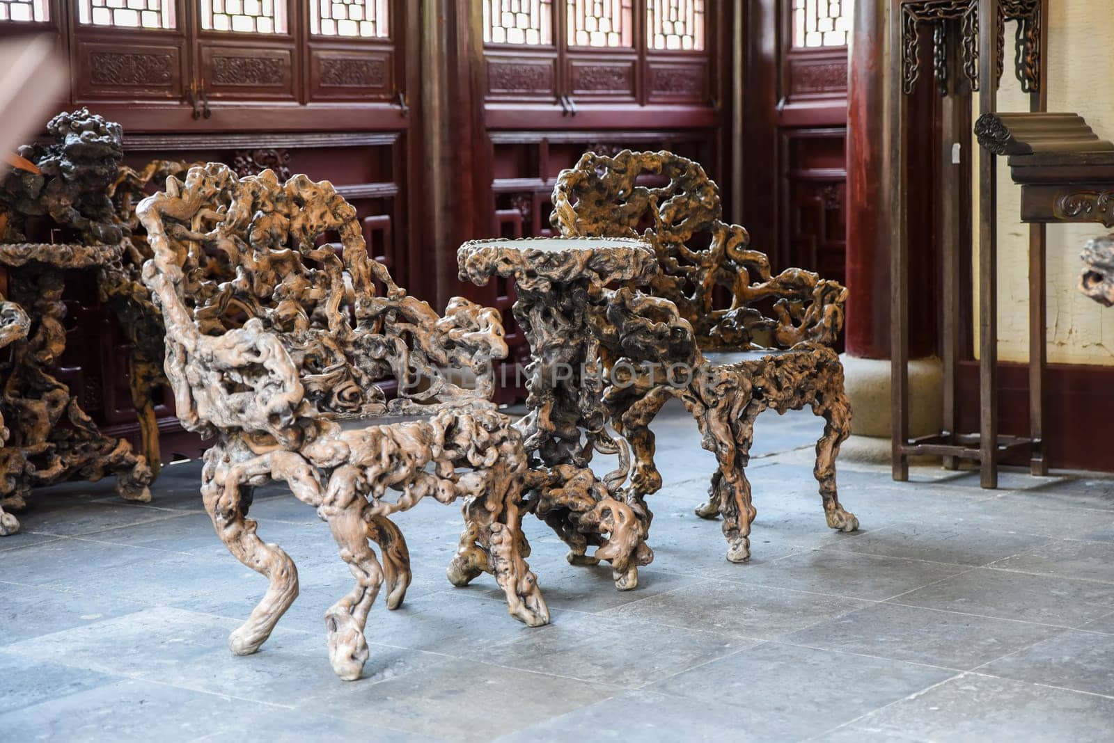 Shanghai, China - 1 April 2025: Interior view of He Xu Hall featuring sculptural chairs made from banyan roots in Dianchun Hall, Yuyuan Garden