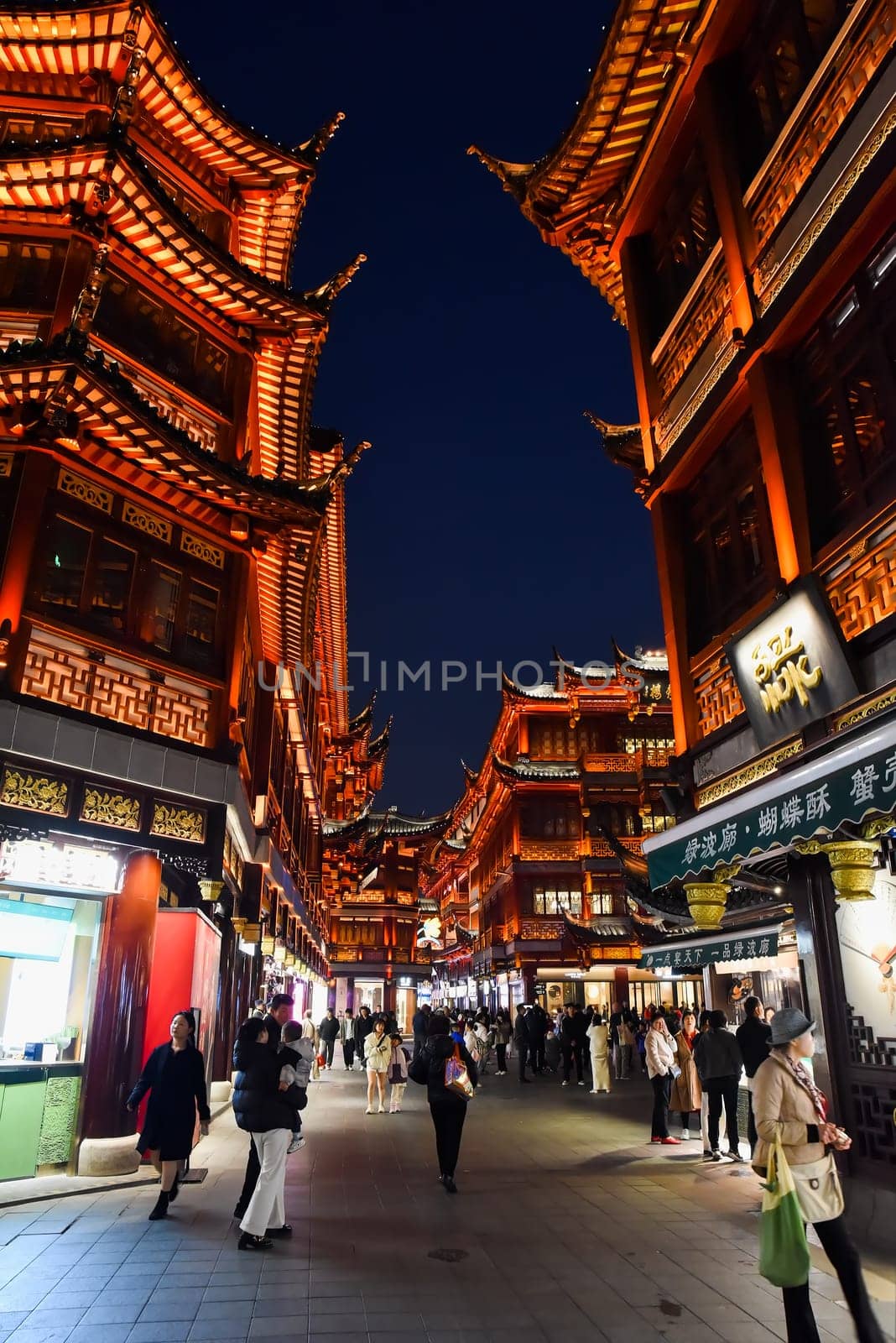 Shanghai, China - 1 April 2025: Shoppers explore Yuyuan Old Street, a bustling market area featuring traditional Chinese architecture and local goods