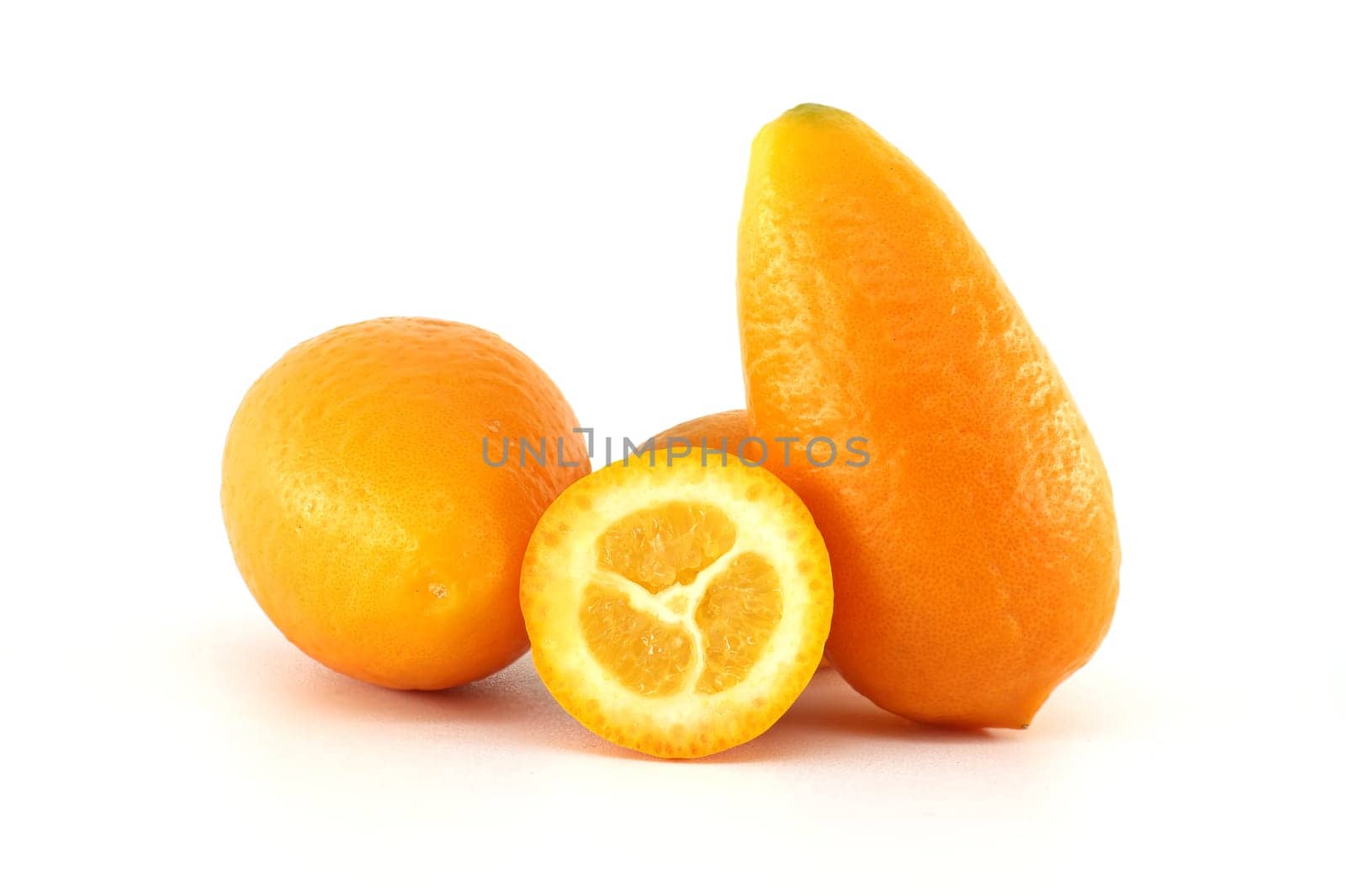 Vibrant orange kumquats, whole and sliced, are displayed on a white background, showcasing their juicy texture and fresh appeal, perfect for healthy eating and citrusy recipes