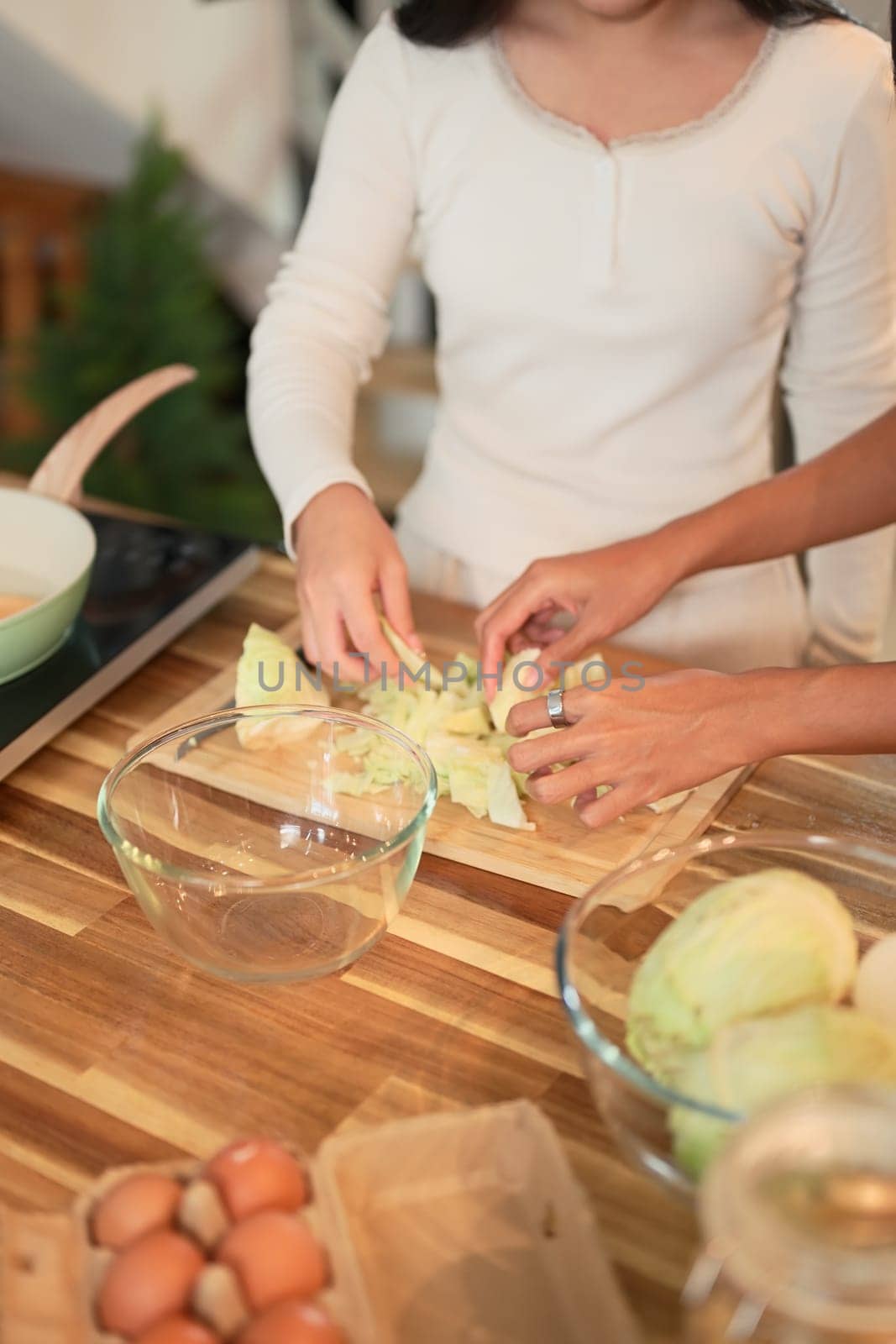 Smiling mother and daughter preparing a healthy meal together in a cozy kitchen at home.