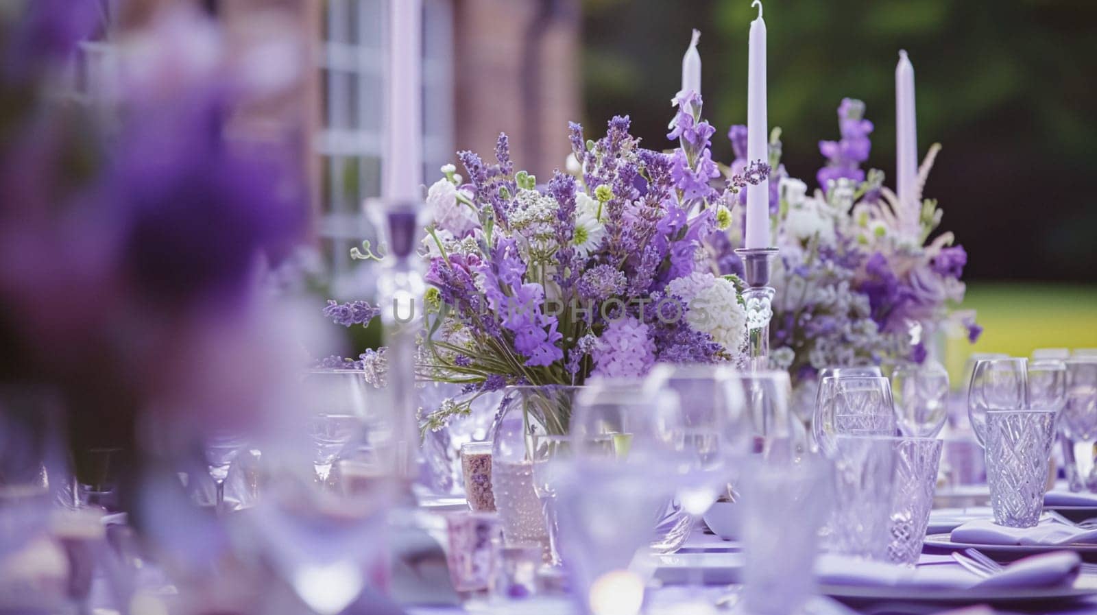 Outdoor wedding buffet table with lavender and a variety of dishes.