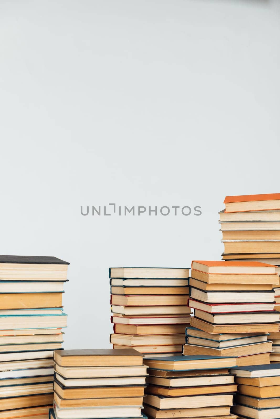 Stacks of old educational books for learning on a white background