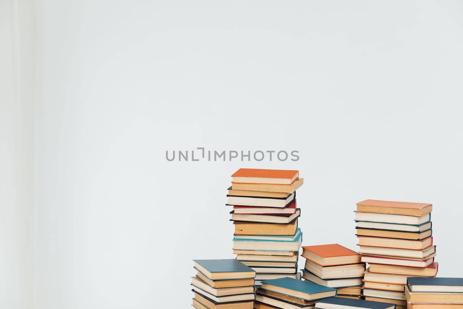 Stacks of old educational books for learning on a white background