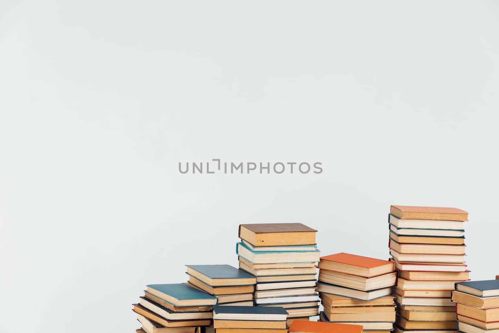 Stacks of old educational books for learning on a white background