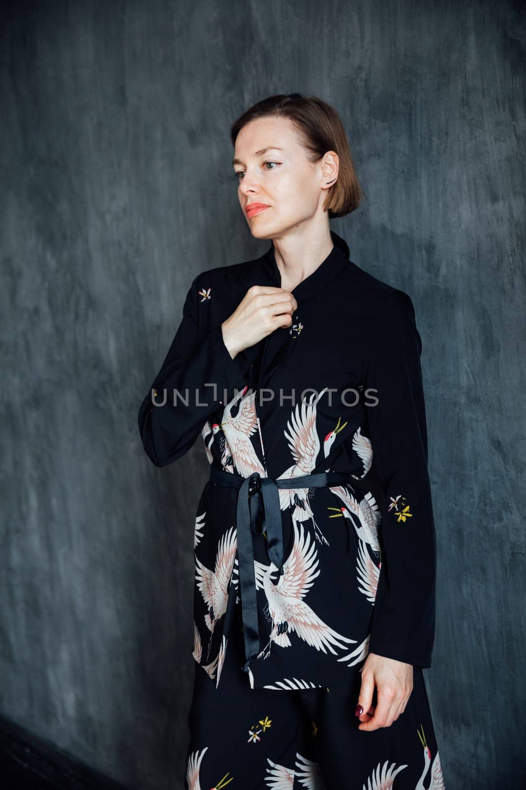 Fashionable woman 40 years old in black suit portrait