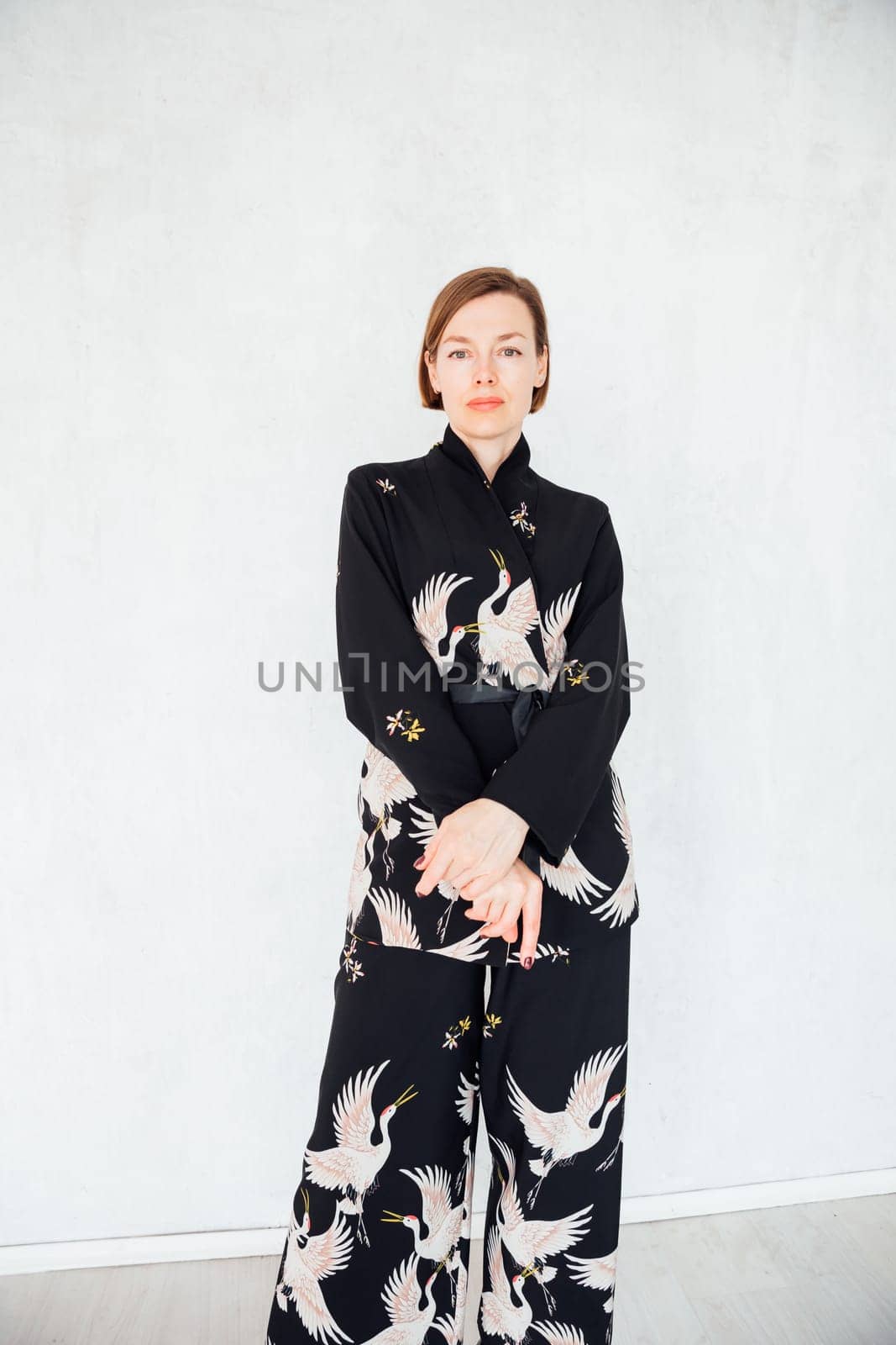 Fashionable woman 40 years old in black suit portrait