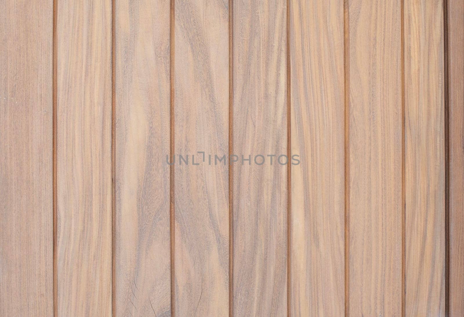 Vertical wooden planks creating a warm, textured background, a fragment of a house door, an ideal building material for cladding, a concept of a natural surface,